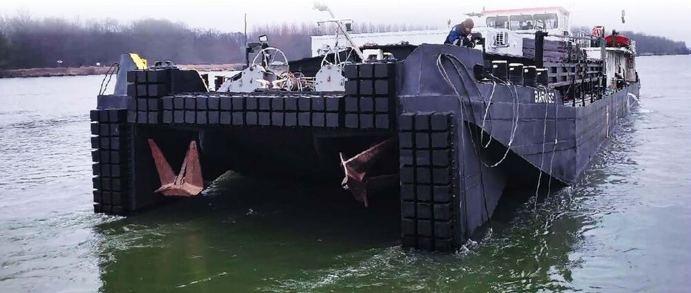 Vessel with black pushing boxes fitted to its bow
