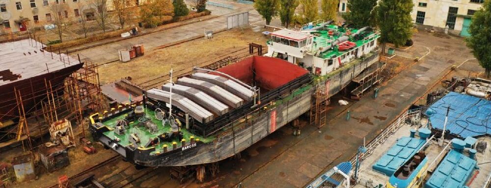 Aerial view of a converted river pusher on the slipway